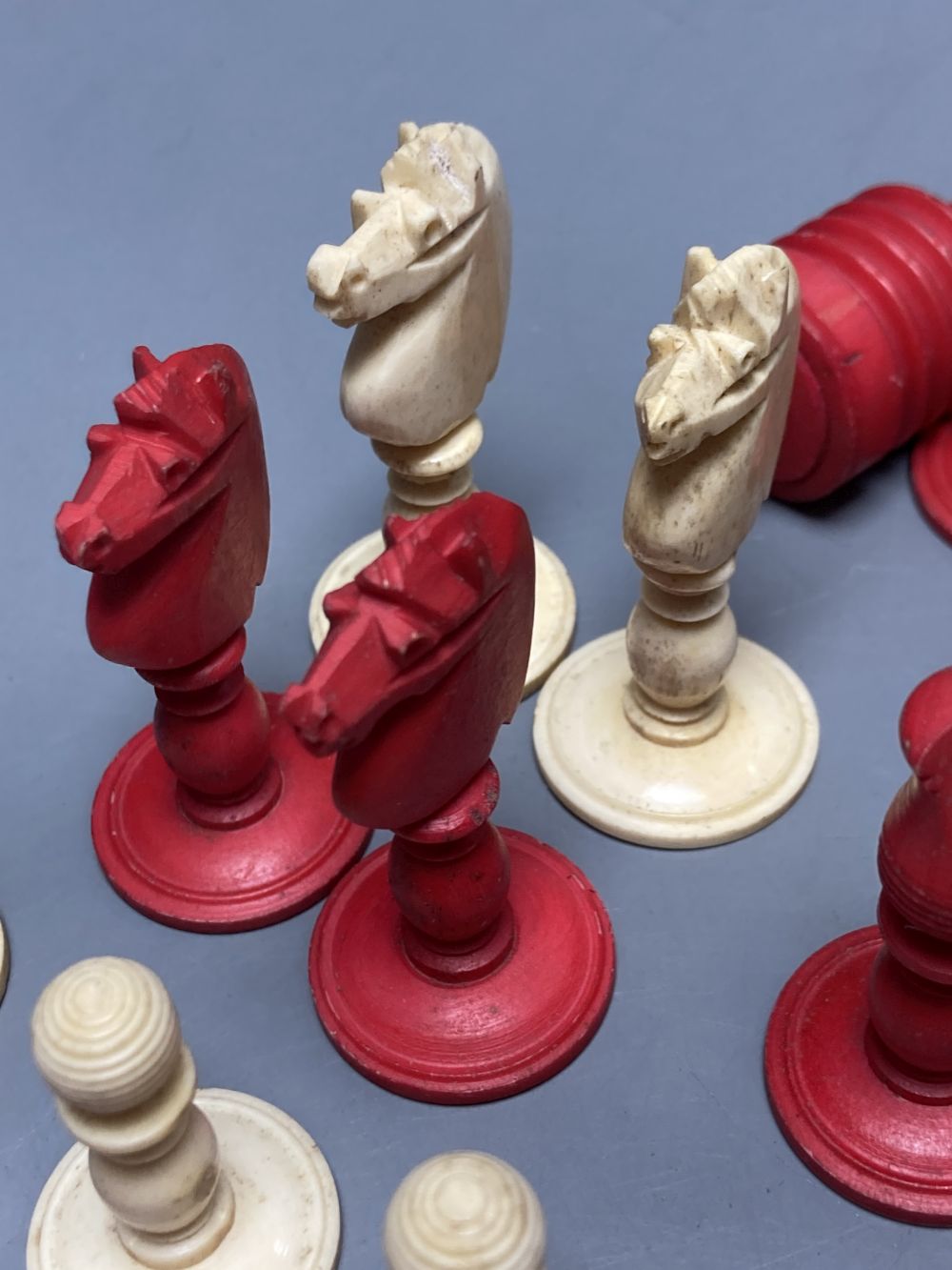 A late 19th century stained natural bone chess set